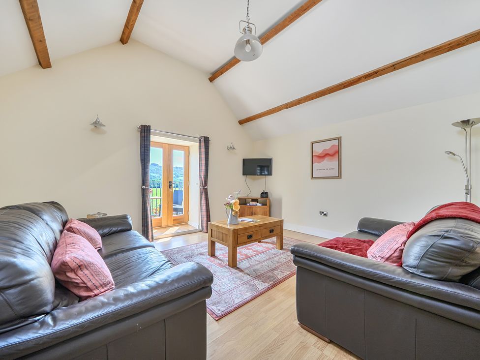 A living room with sofas and a coffee table at The Granary in Corwen
