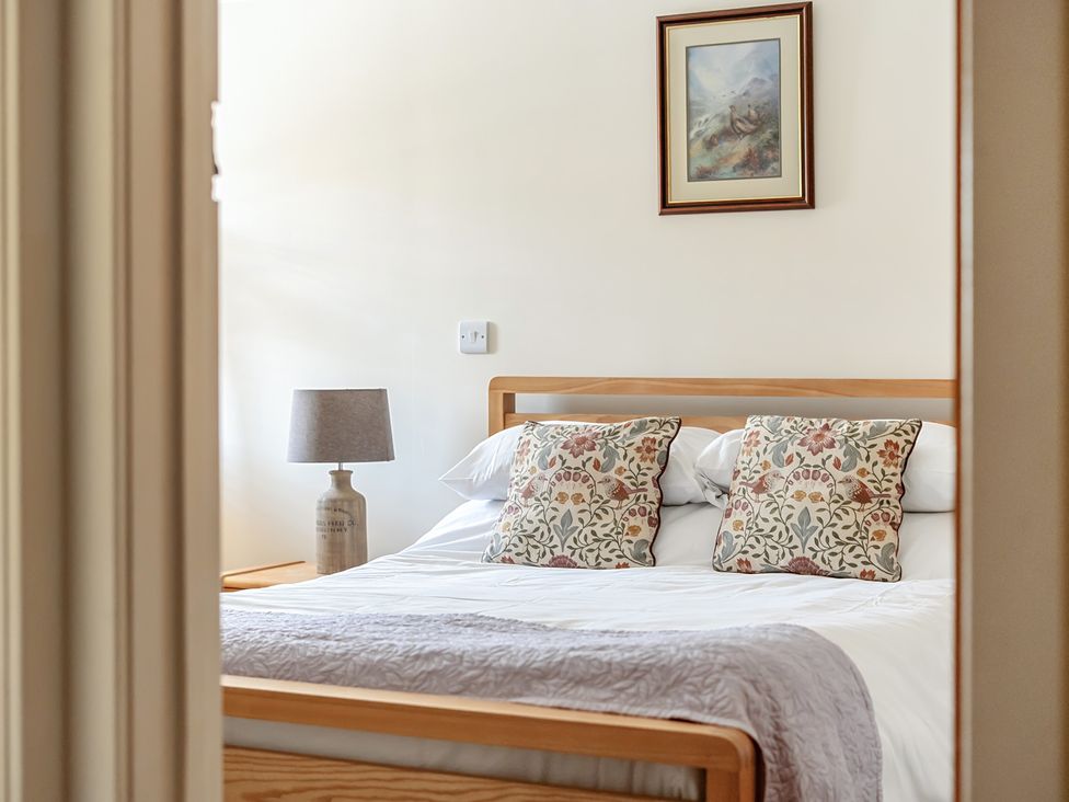 A bedroom with a bed and pillows at The Granary in Corwen