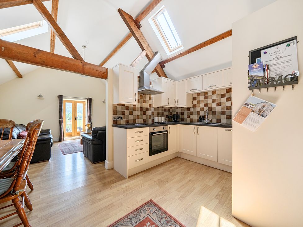 A kitchen with dining area and seating at The Granary in Corwen