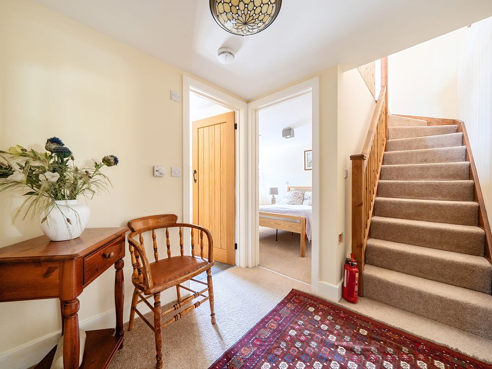 A hallway with a table and chair at The Granary in Corwen