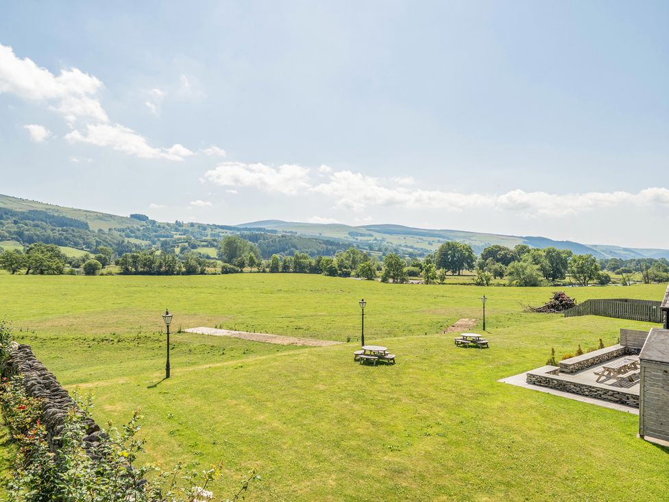 A field with tables and benches at The Granary in Corwen