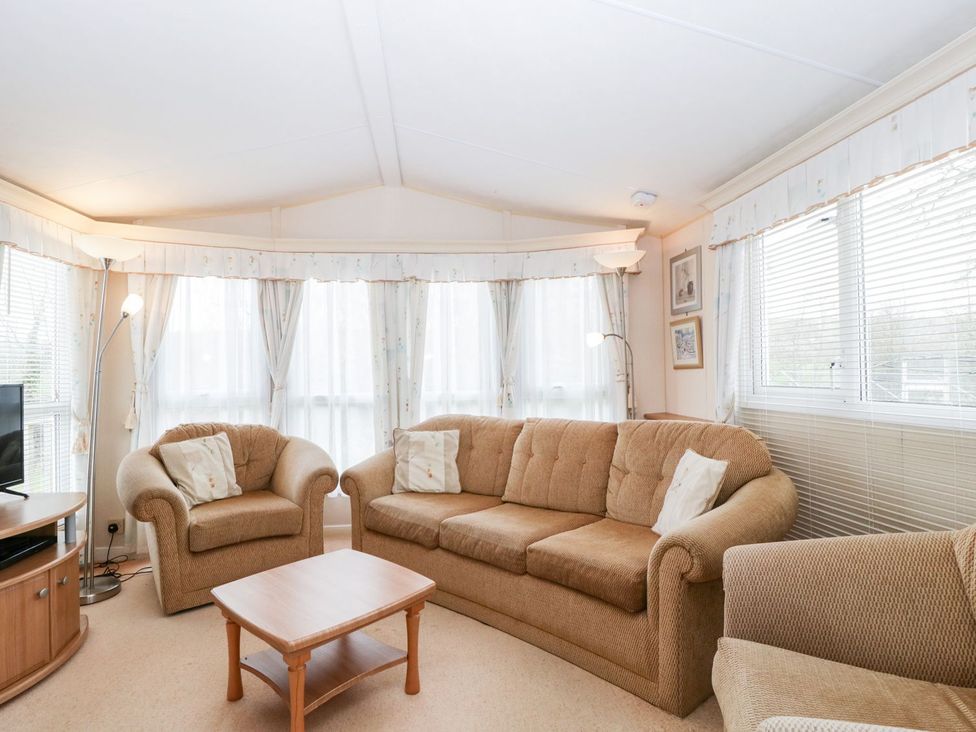 A living room with a sofa and armchair at The Hideaway in Portesham