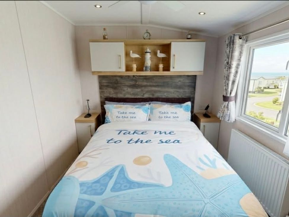 A bedroom with a bed and decorative items at Marton mere Westminster Blackpool