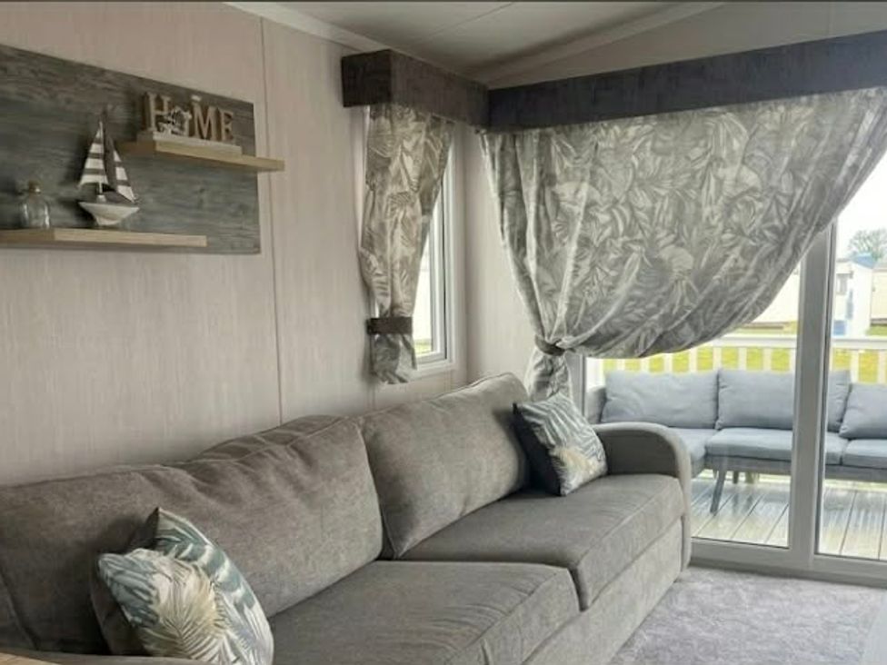 A living room with a sofa and decorative items at Marton mere Westminster Blackpool