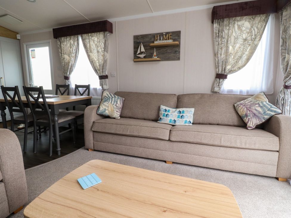 A living room with a sofa and dining table at Marton Mere Westminster in Blackpool