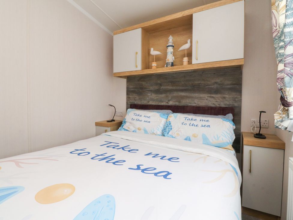 A bedroom with a bed and decorative items at Marton Mere Westminster in Blackpool