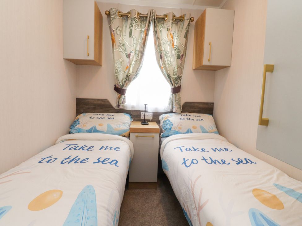 A bedroom with two beds and a window at Marton Mere Westminster in Blackpool