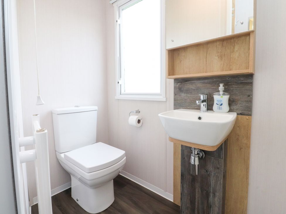 A bathroom with a toilet and sink at Marton Mere Westminster in Blackpool
