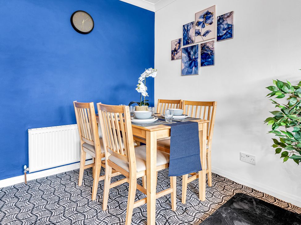 A dining room with a table and chairs at Mallory House in Stoke-on-Trent