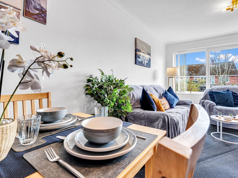 A living room with a dining table and sofa at Mallory House Stoke-on-Trent