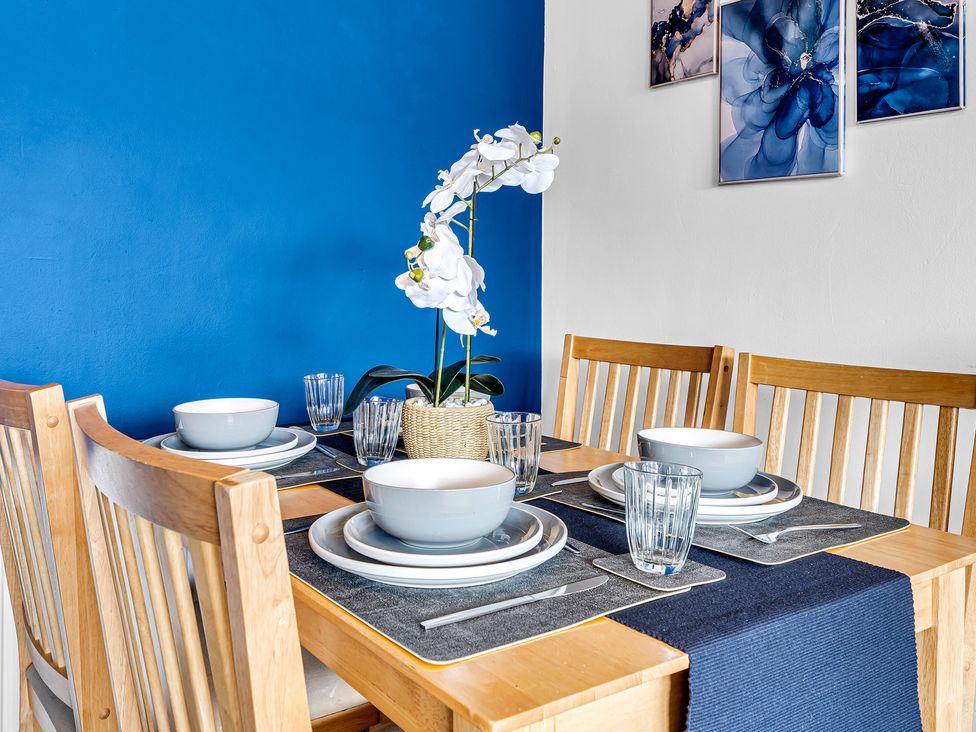 A dining table set with bowls and glassware at Mallory House in Stoke-on-Trent