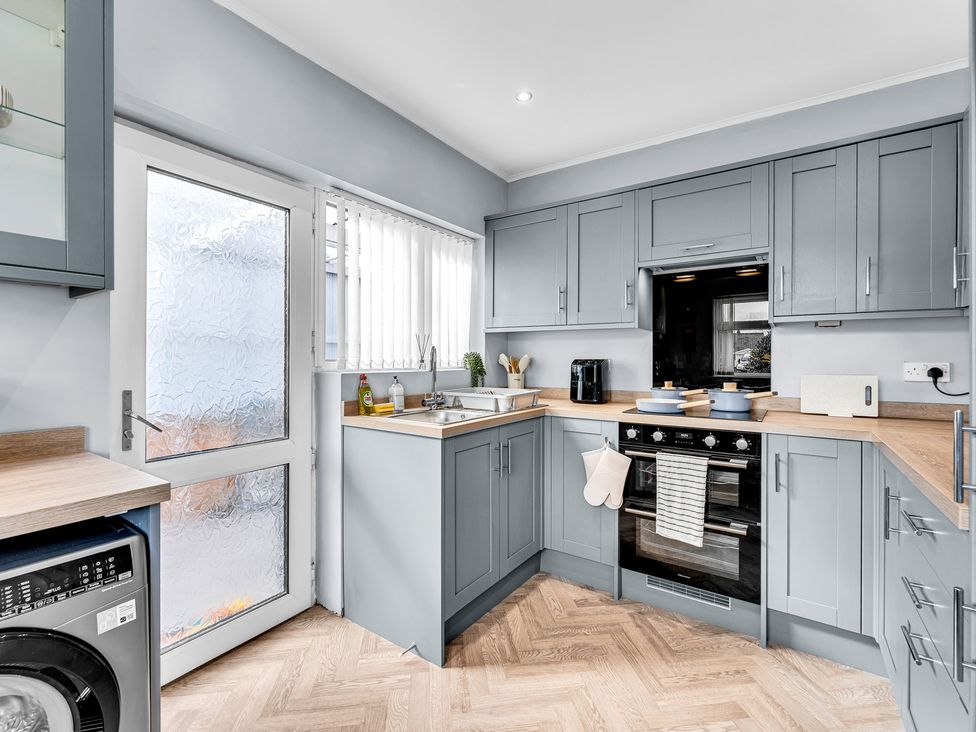 A kitchen with cabinets and appliances at Mallory House in Stoke-on-Trent