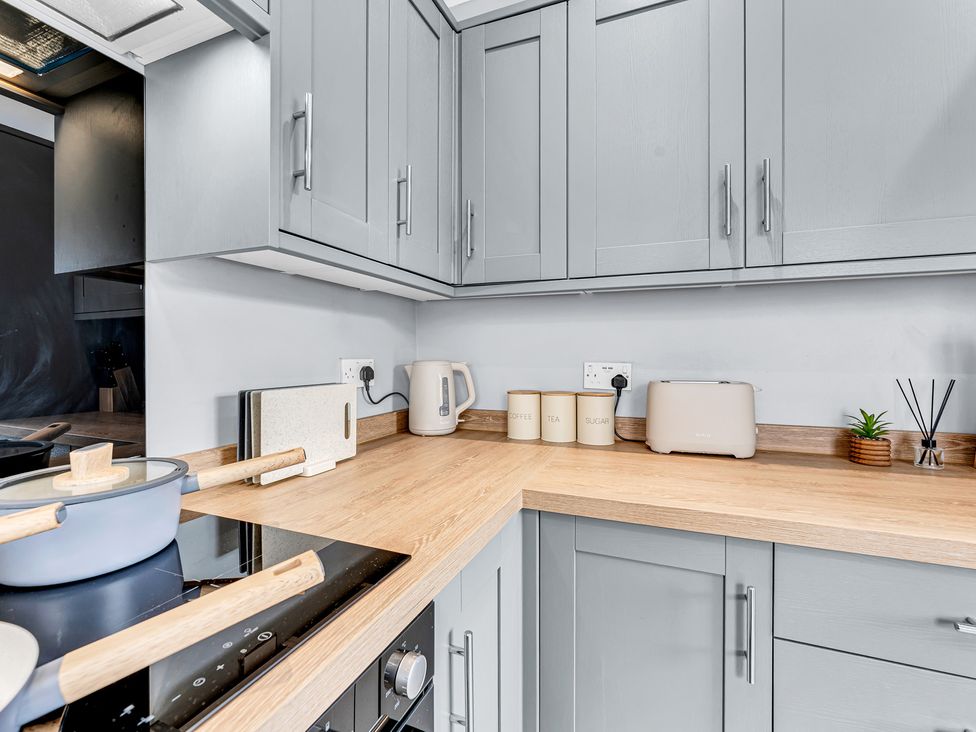 A kitchen with cabinets, countertop, toaster and kettle at Mallory House in Stoke-on-Trent