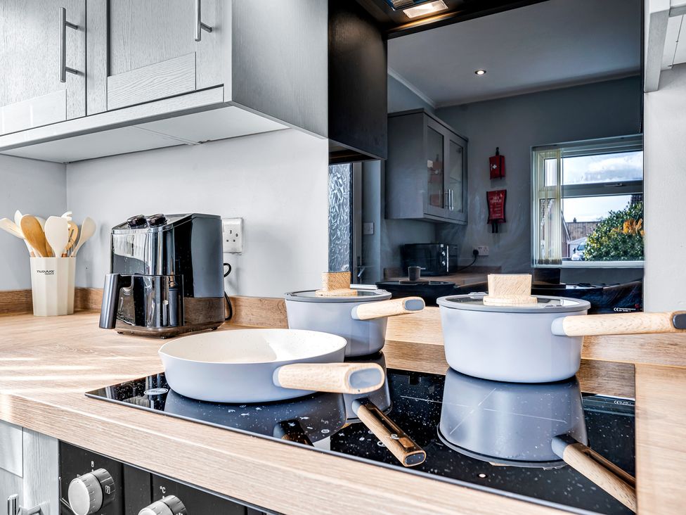 A kitchen with cooking pots and an air fryer at Mallory House in Stoke-on-Trent
