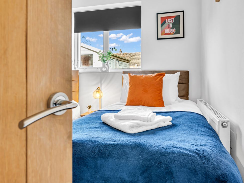 A bedroom with a bed and decorative items at Mallory House in Stoke-on-Trent