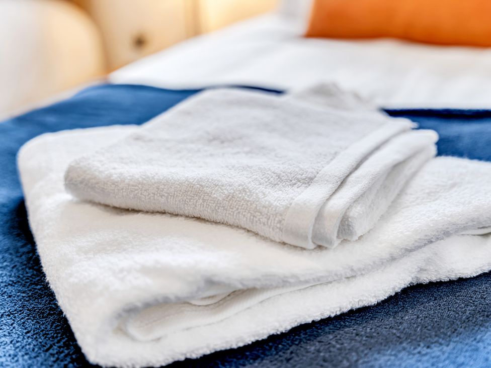 Towels folded on a bed at Mallory House in Stoke-on-Trent