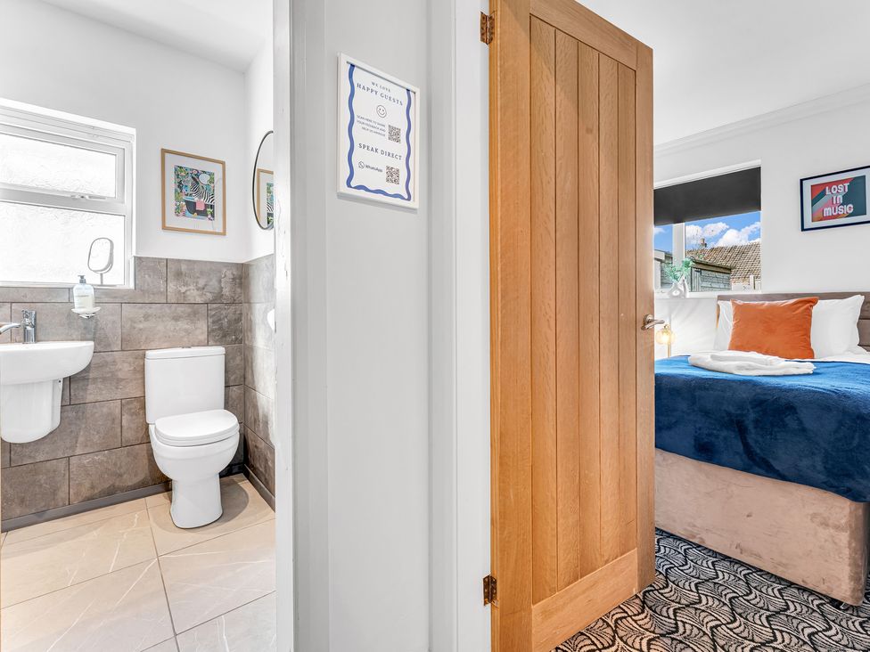 A bathroom with a toilet and sink at Mallory House in Stoke-on-Trent