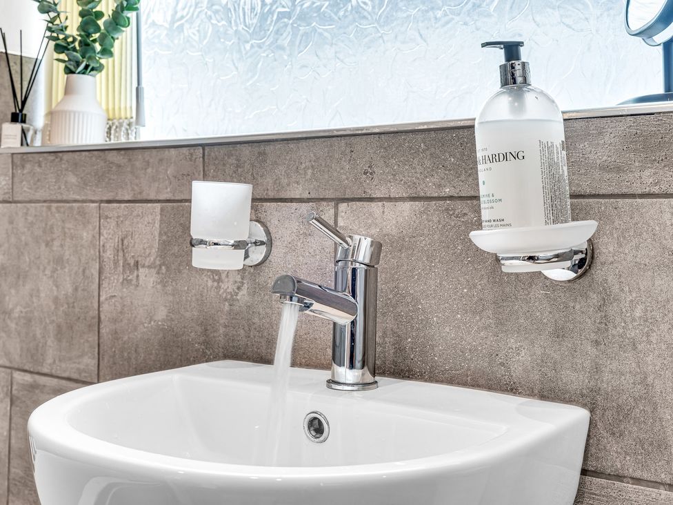 A sink with a faucet and soap dispenser at Mallory House in Stoke-on-Trent