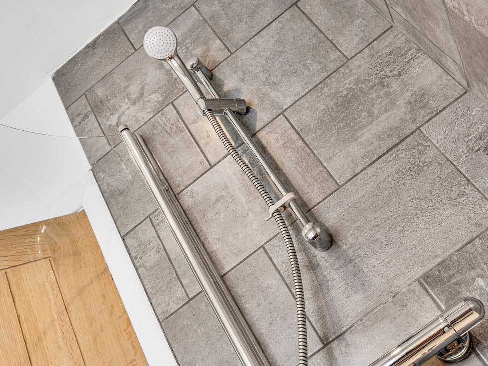 A shower with a handheld showerhead and hose in Mallory House Stoke-on-Trent
