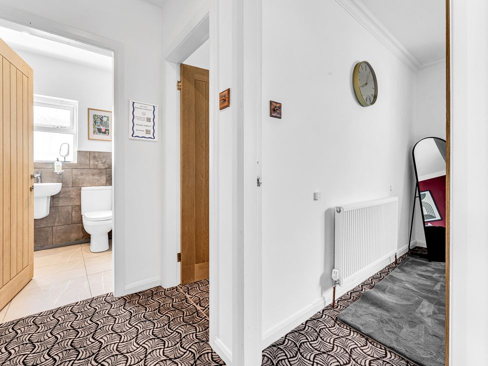 A bathroom with a toilet and sink at Mallory House in Stoke-on-Trent