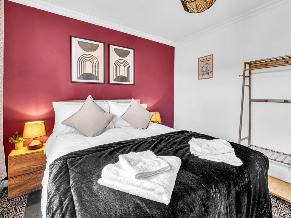 A bedroom with a bed and bedside lamp at Mallory House in Stoke-on-Trent