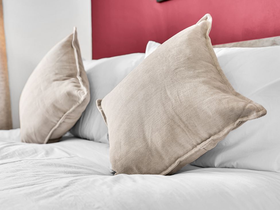 A bed with two pillows at Mallory House in Stoke-on-Trent