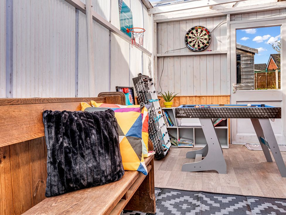 A snug with a bench and an air hockey table at Mallory House in Stoke-on-Trent