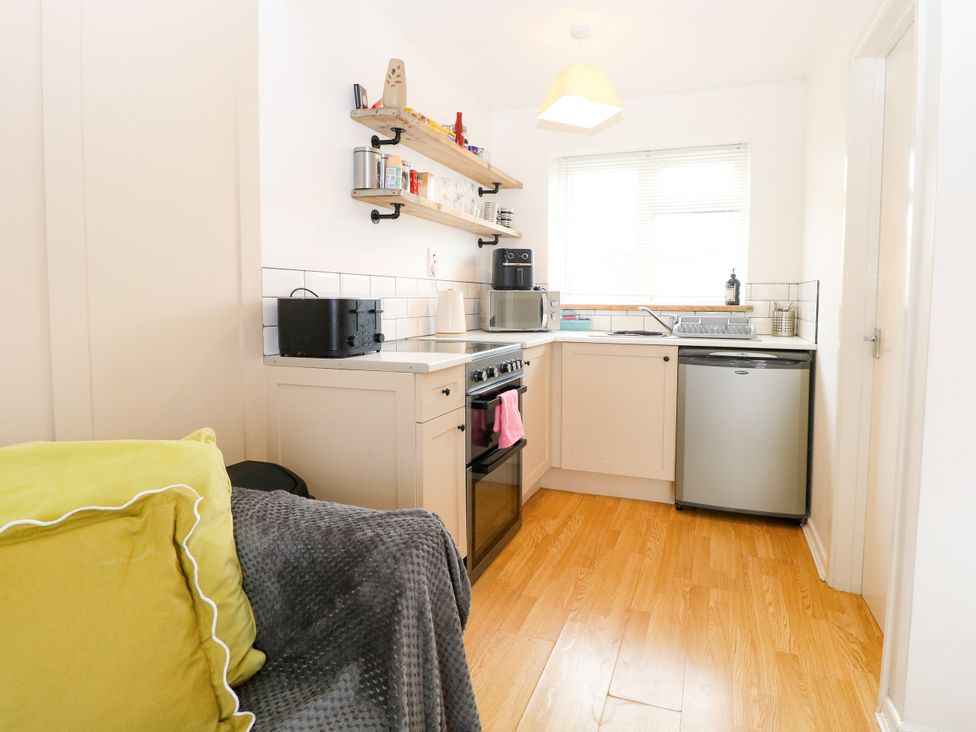 A kitchen with appliances and a sink at Leaf Lodge in Hemsby