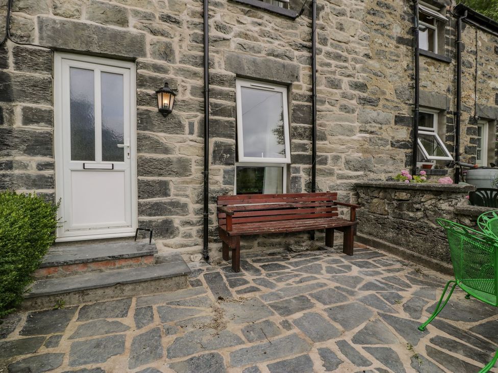 An outdoor area with a bench and door at Awelfryn in Betws-y-Coed