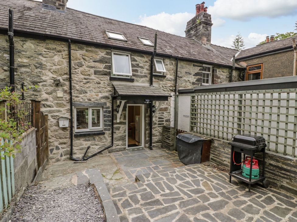 An outdoor area with a back door and grill at Awelfryn in Betws-y-Coed