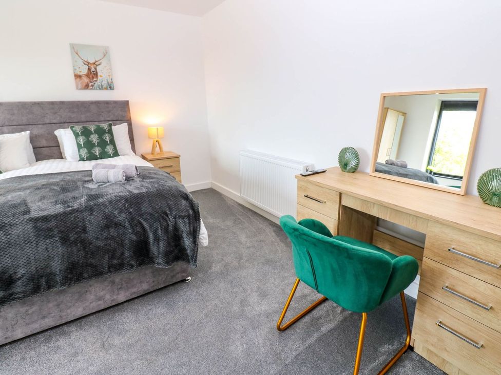 A bedroom with a bed and desk in Sycamore Cottage in Frizington