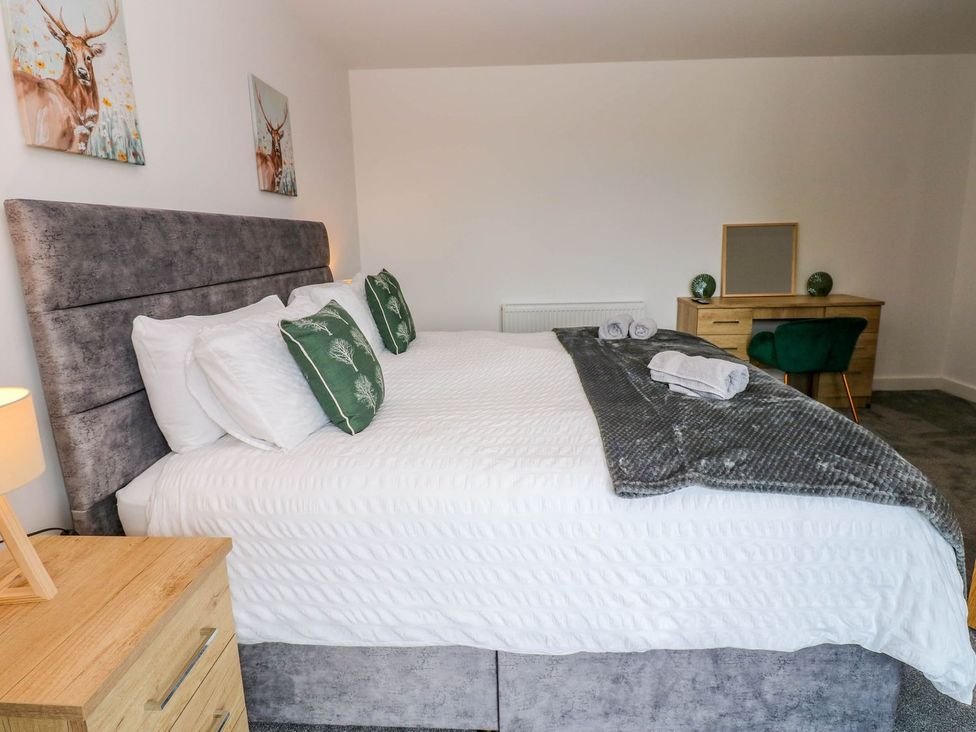 A bedroom with a bed and desk at Sycamore Cottage in Frizington