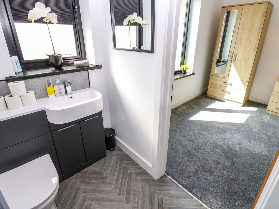 A bathroom with a sink and toilet at Sycamore Cottage in Frizington