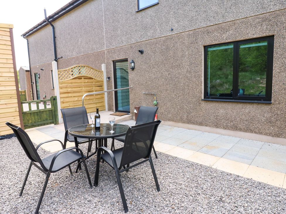 An outdoor area with a table and chairs at Sycamore Cottage in Frizington