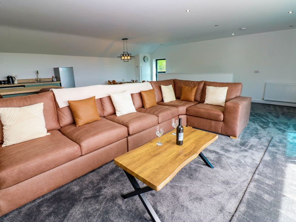 A living room with a sofa and coffee table at Silver Birch Cottage in Frizington