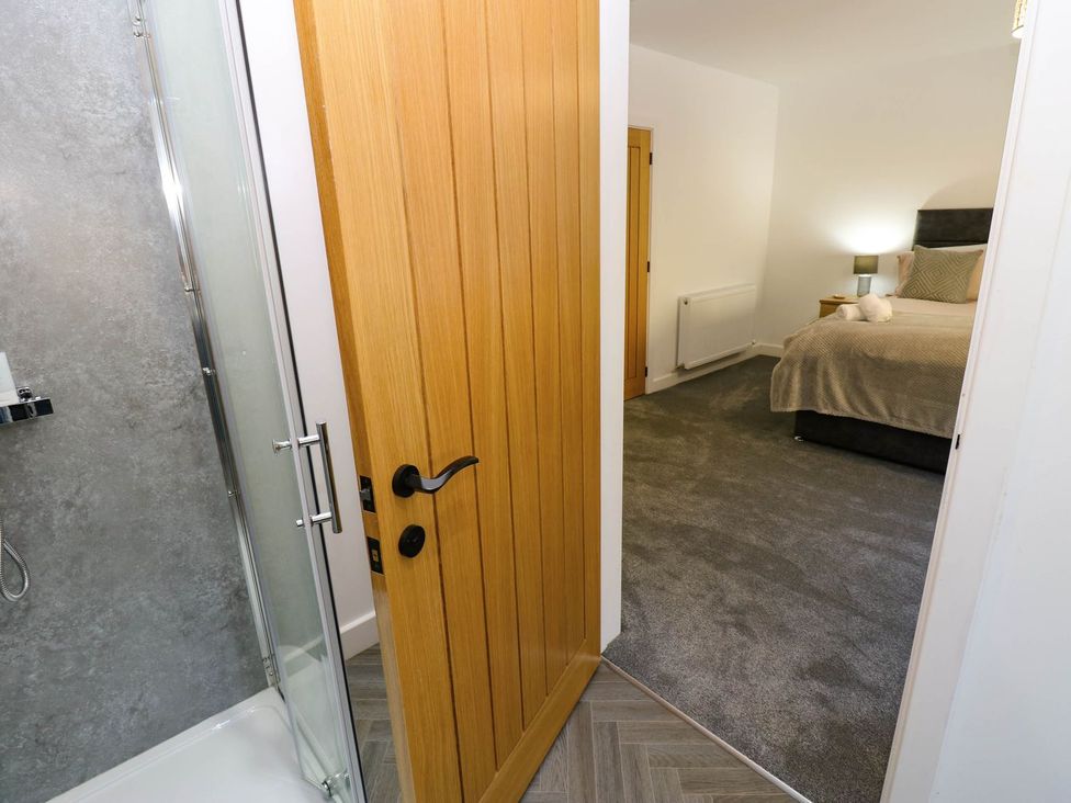 A bedroom with a shower visible from the doorway at Silver Birch Cottage in Frizington
