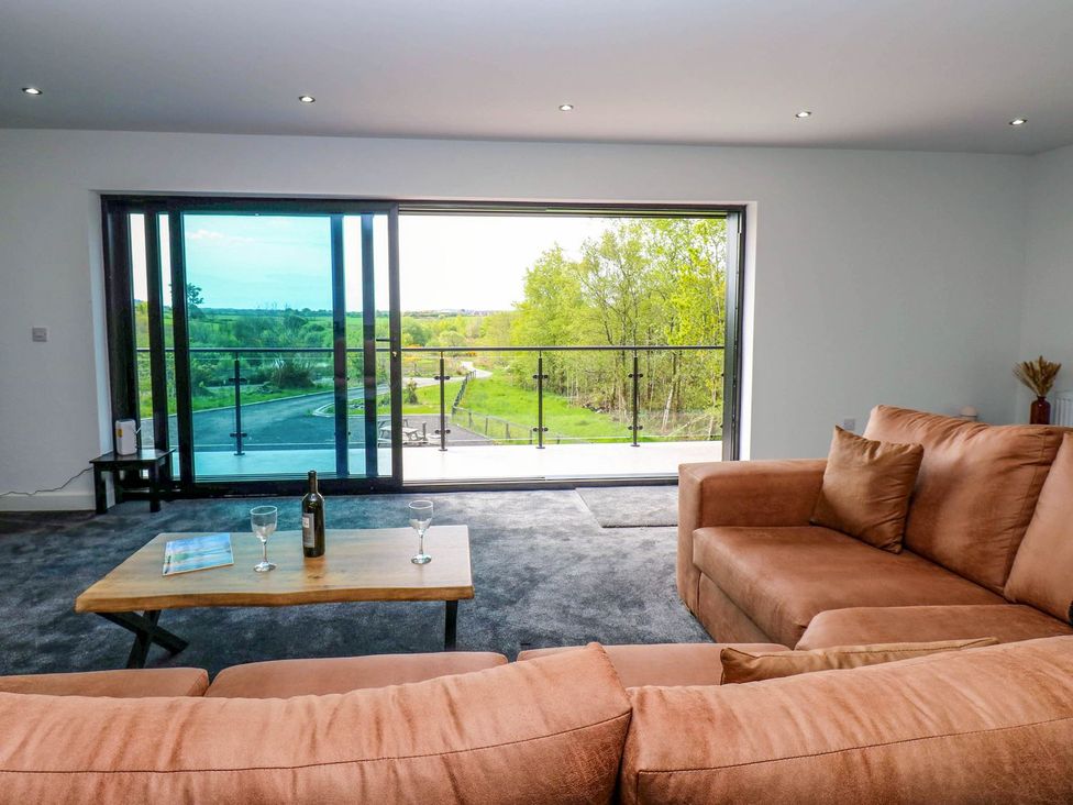 A living room with a sofa and coffee table at Oak Tree Cottage in Frizington