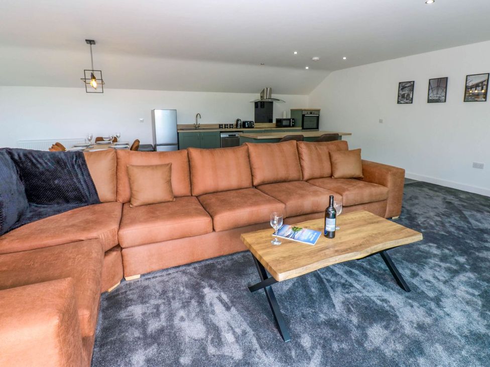 A living room with a sofa and coffee table at Oak Tree Cottage in Frizington