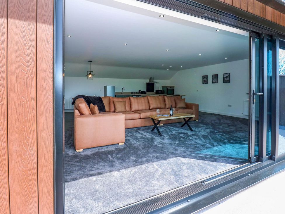 A living room with a sofa and table at Oak Tree Cottage in Frizington