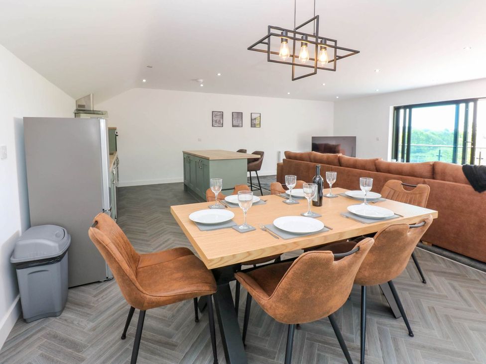 A dining area with a table and chairs at Oak Tree Cottage in Frizington