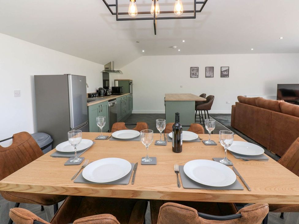 A kitchen with a dining table and chairs at Oak Tree Cottage in Frizington