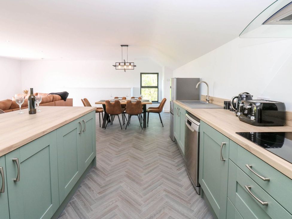 A kitchen with a dining area visible at Oak Tree Cottage in Frizington