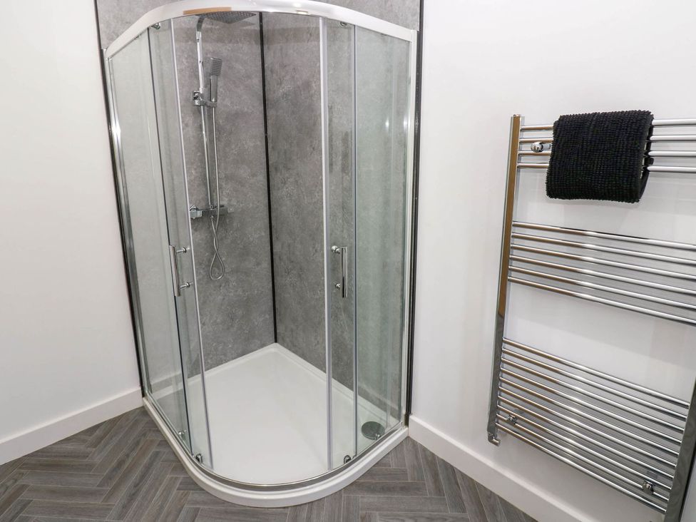 A shower and towel rail in Oak Tree Cottage Frizington
