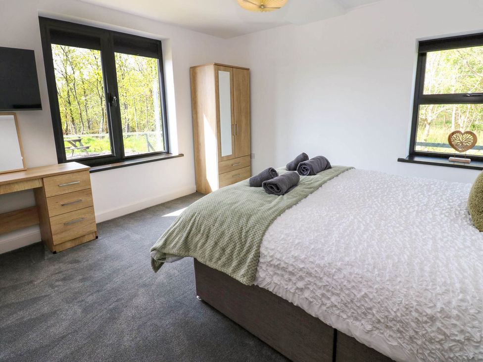 A bedroom with a bed and desk at Oak Tree Cottage in Frizington