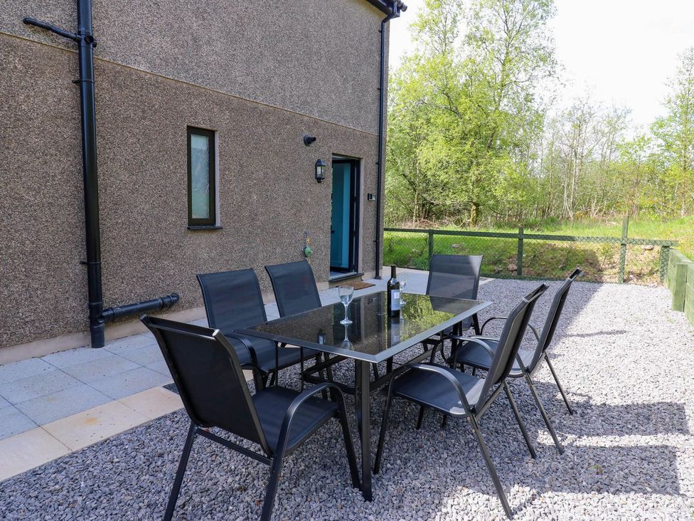 An outdoor area with a table and chairs at Oak Tree Cottage in Frizington