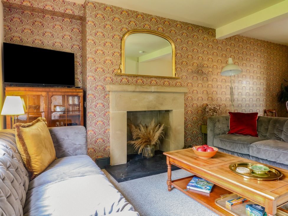 A living room with a coffee table and a television at Haarlem House in Wirksworth