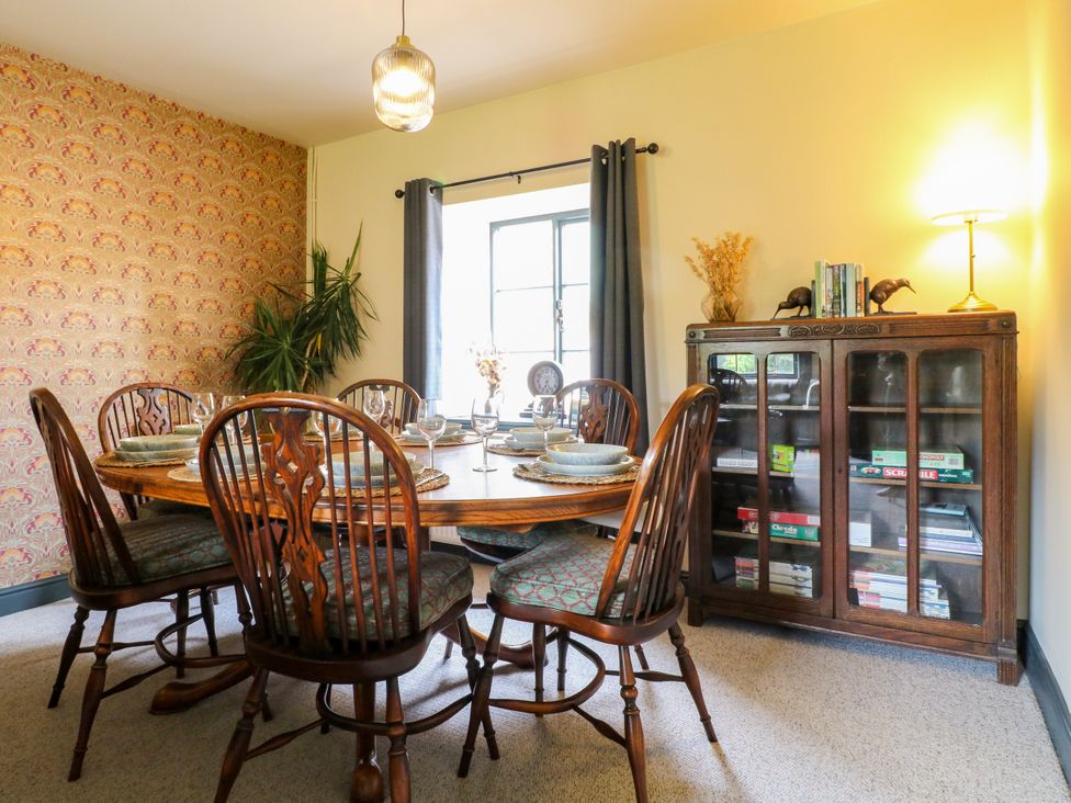 A dining room with a wooden table and chairs at Haarlem House Wirksworth