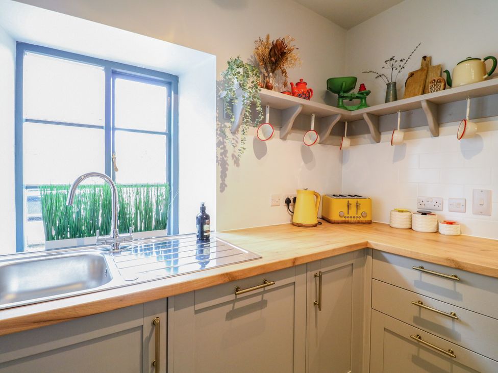 A kitchen with a sink and window at Haarlem House in Wirksworth