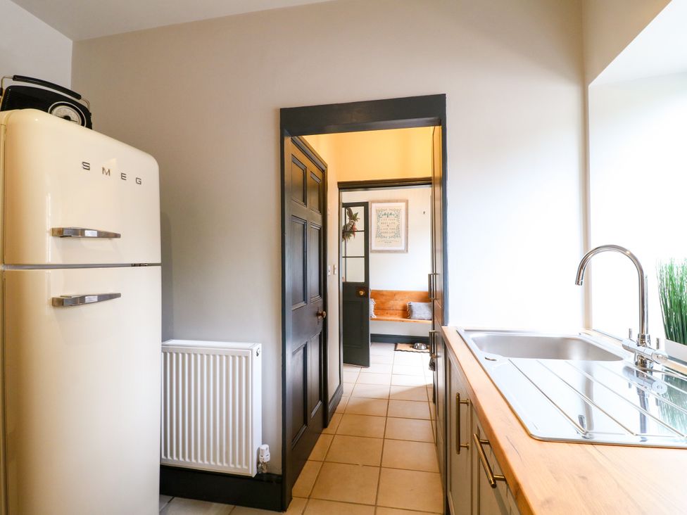 A kitchen with a refrigerator and sink at Haarlem House in Wirksworth