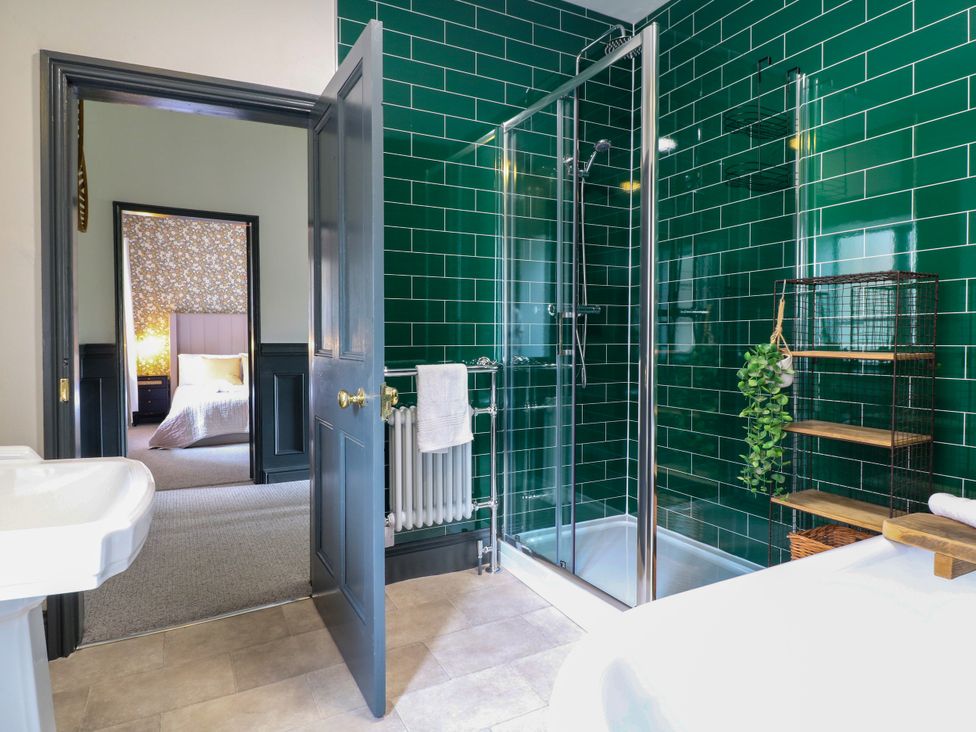 A bathroom with a shower and bathtub at Haarlem House in Wirksworth